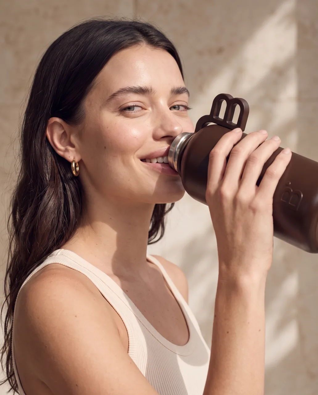 Beau lifestyle campaign, model drinking from the insulated flask in daylight