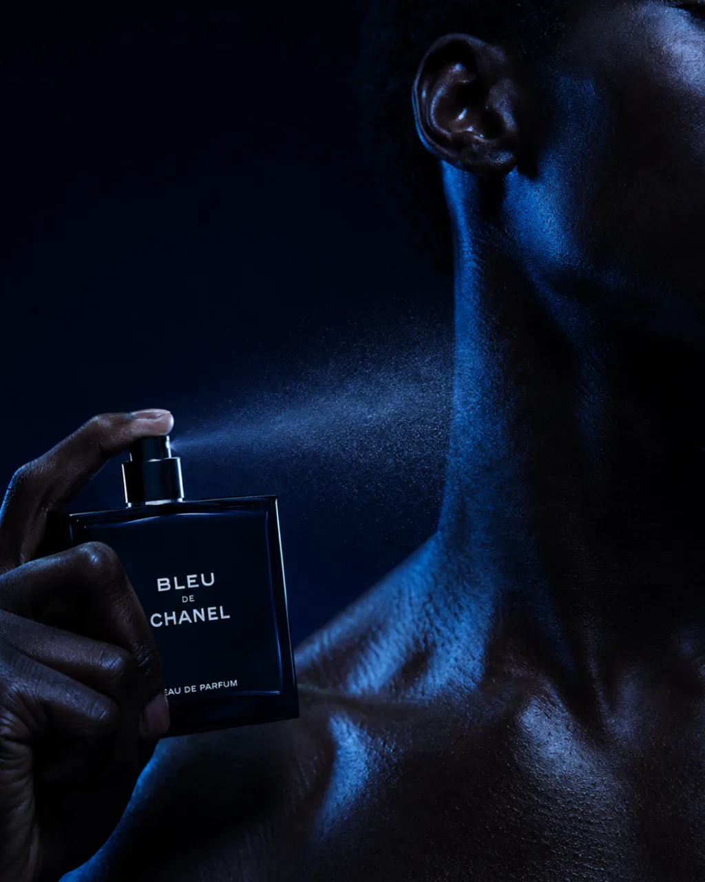 Bleu de Chanel fragrance concept campaign, bottle held against a model's neck