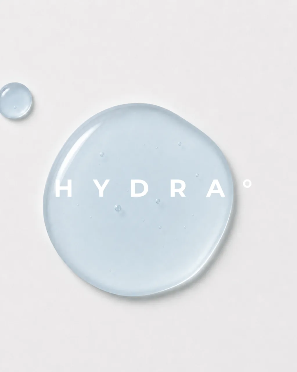 HYDRA key visual: a single drop of serum carrying the HYDRA name on a pale ground