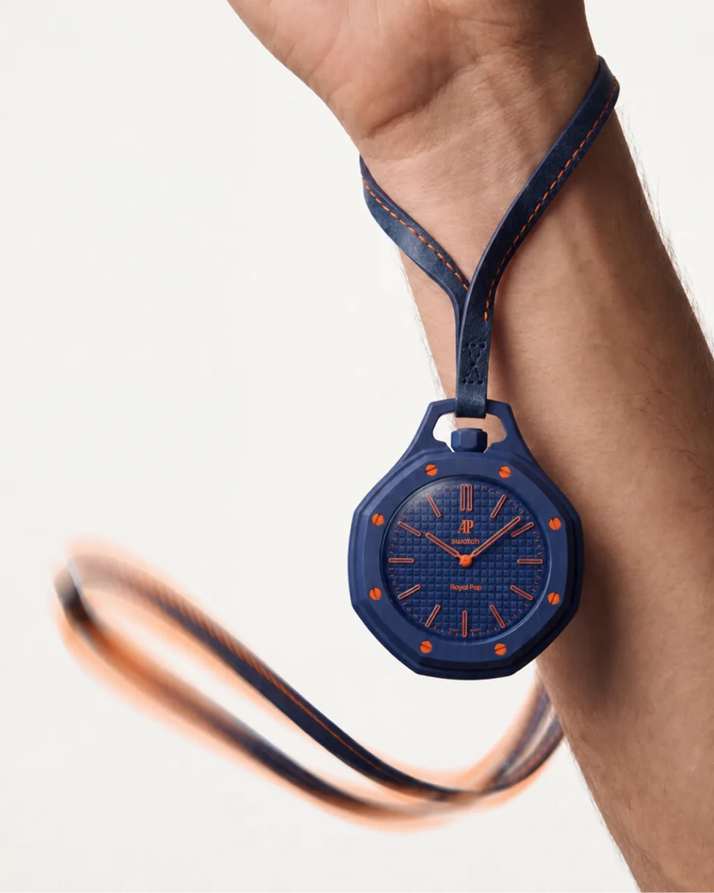 Royal POP concept campaign, navy watch pendant on a cord held at the wrist