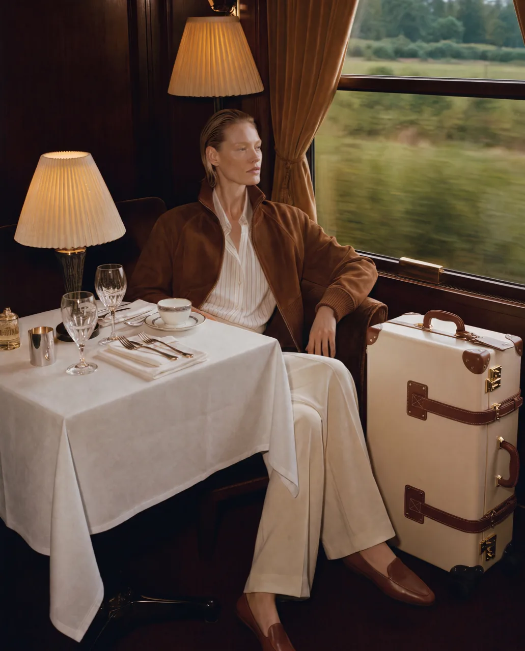 Steamline luggage concept campaign, traveller boarding a train with a trunk case