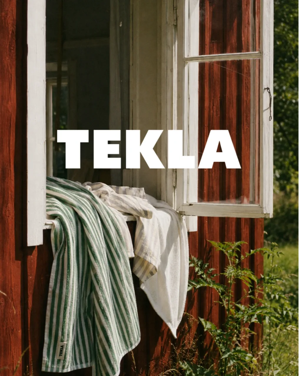 TEKLA key visual: striped towels over an open cabin window, with the TEKLA wordmark