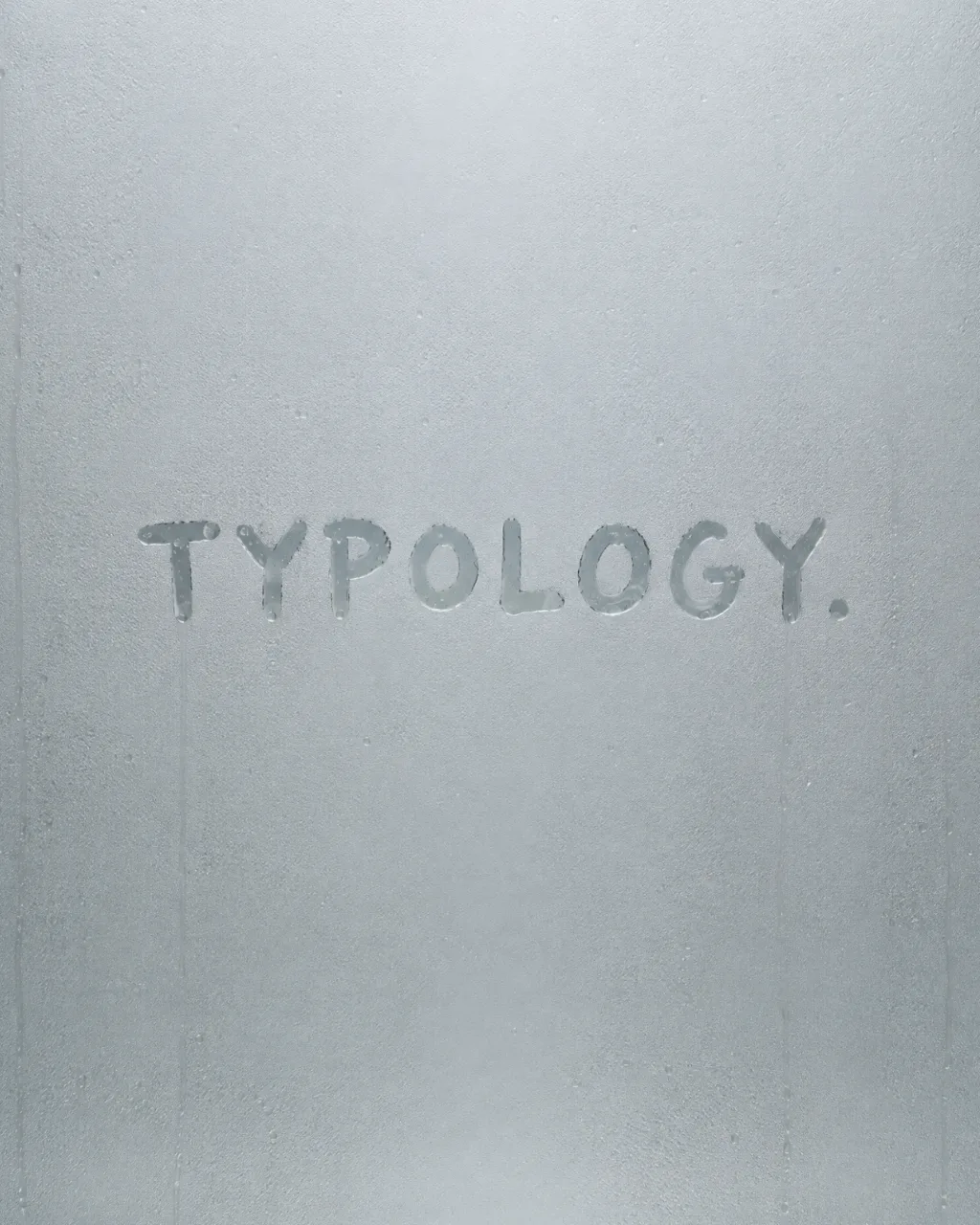 The Typology wordmark written by hand in a steamed bathroom mirror